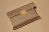Brown paper package with a WellRead yellow label on a beige background